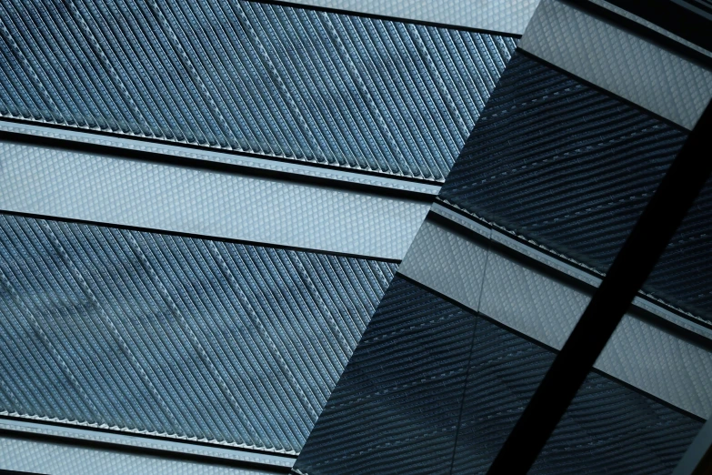 a modern building's shiny facade is seen in this image