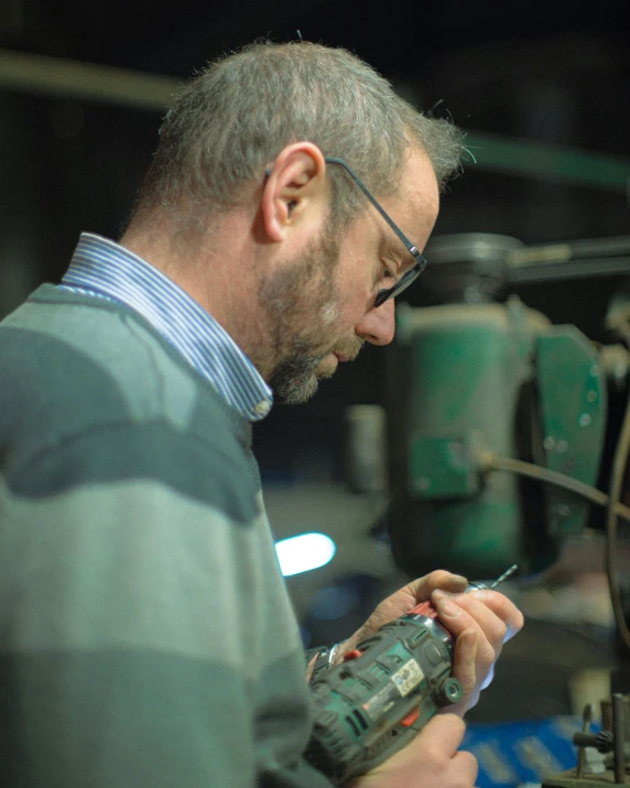 a man is using a small metal machine