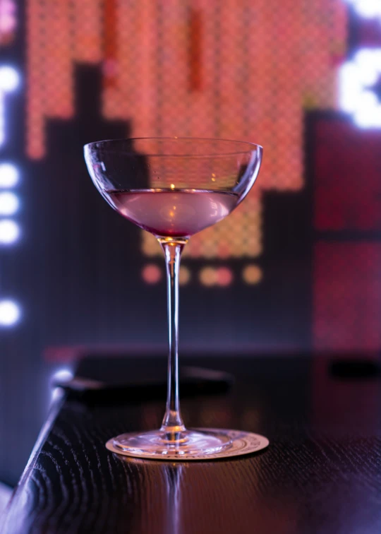 an alcoholic cocktail sitting in a wine glass