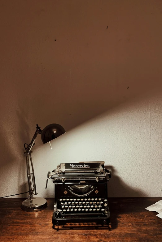 old fashioned typewriter on desk with light coming through the window