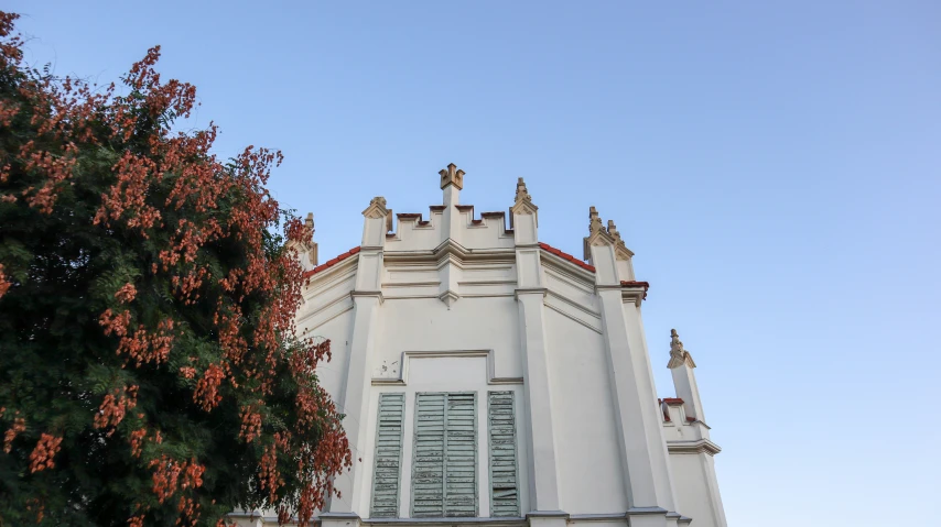 there is a white building with a clock at the top