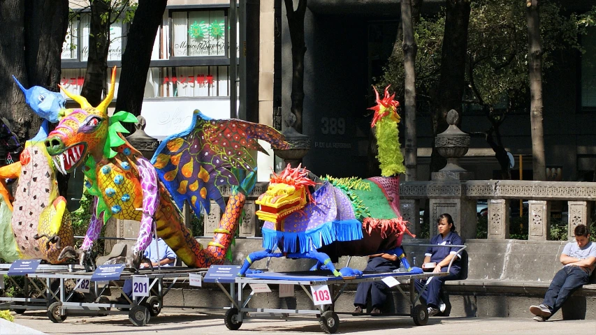 three colorful animals and men sit on bench next to each other