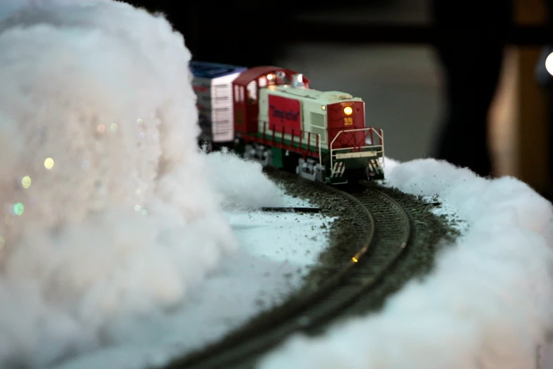 toy train sitting on tracks in white foam