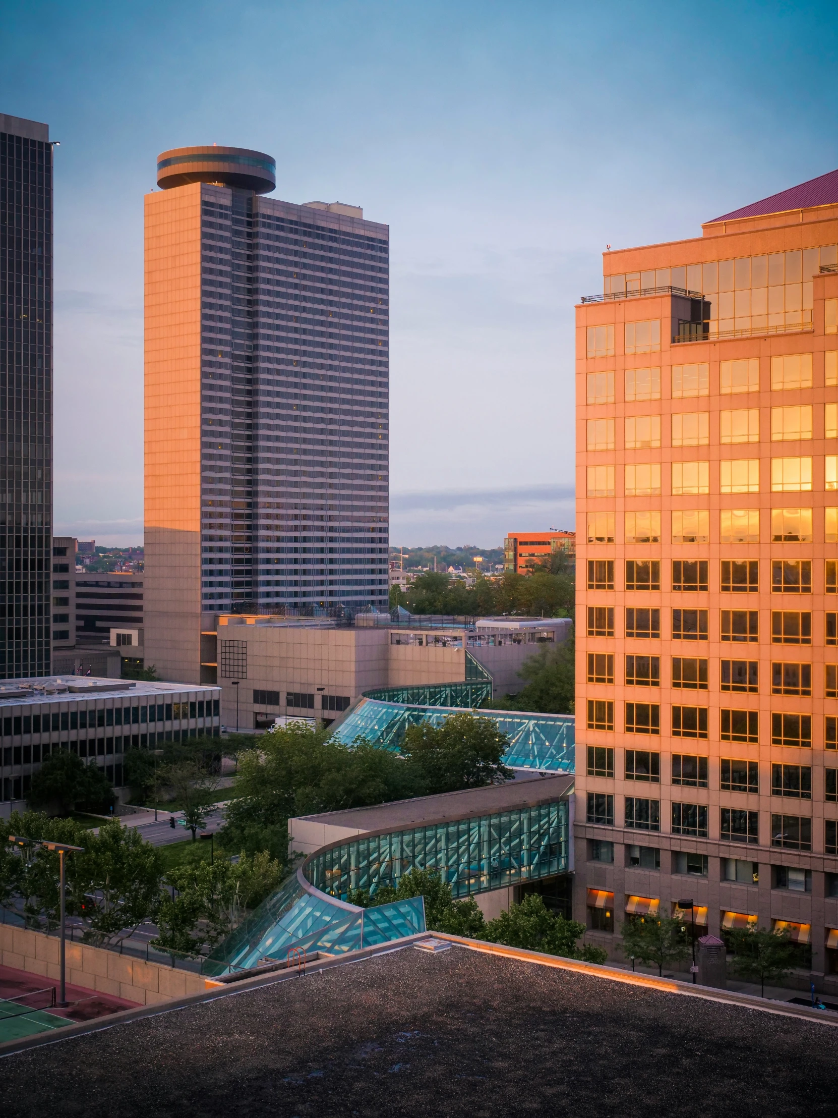 an image of a city at dusk with skyscrs