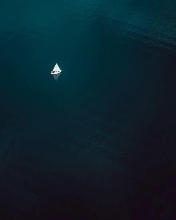 a lone boat in the middle of an ocean