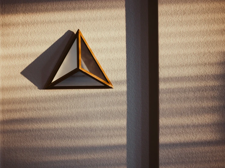a geometric sculpture against a light colored wall