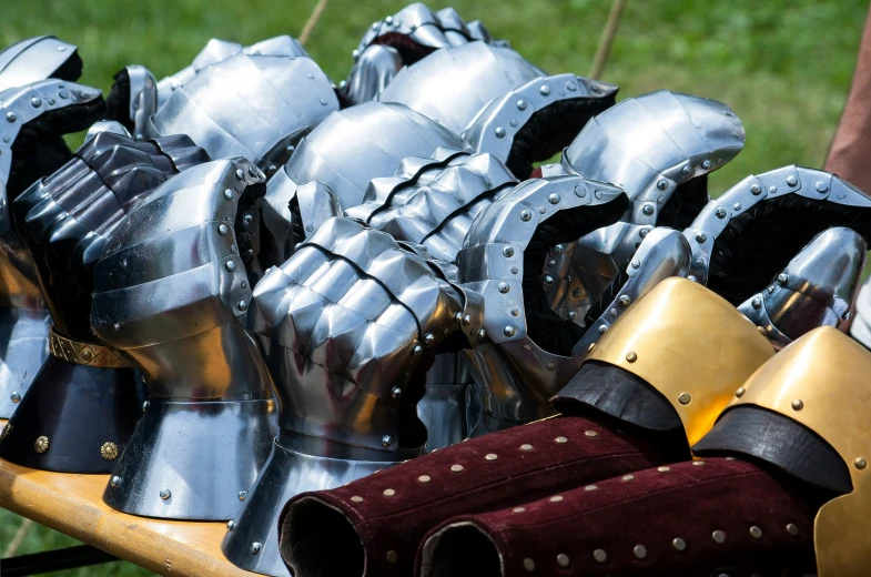 a couple of knights armor sitting in the grass