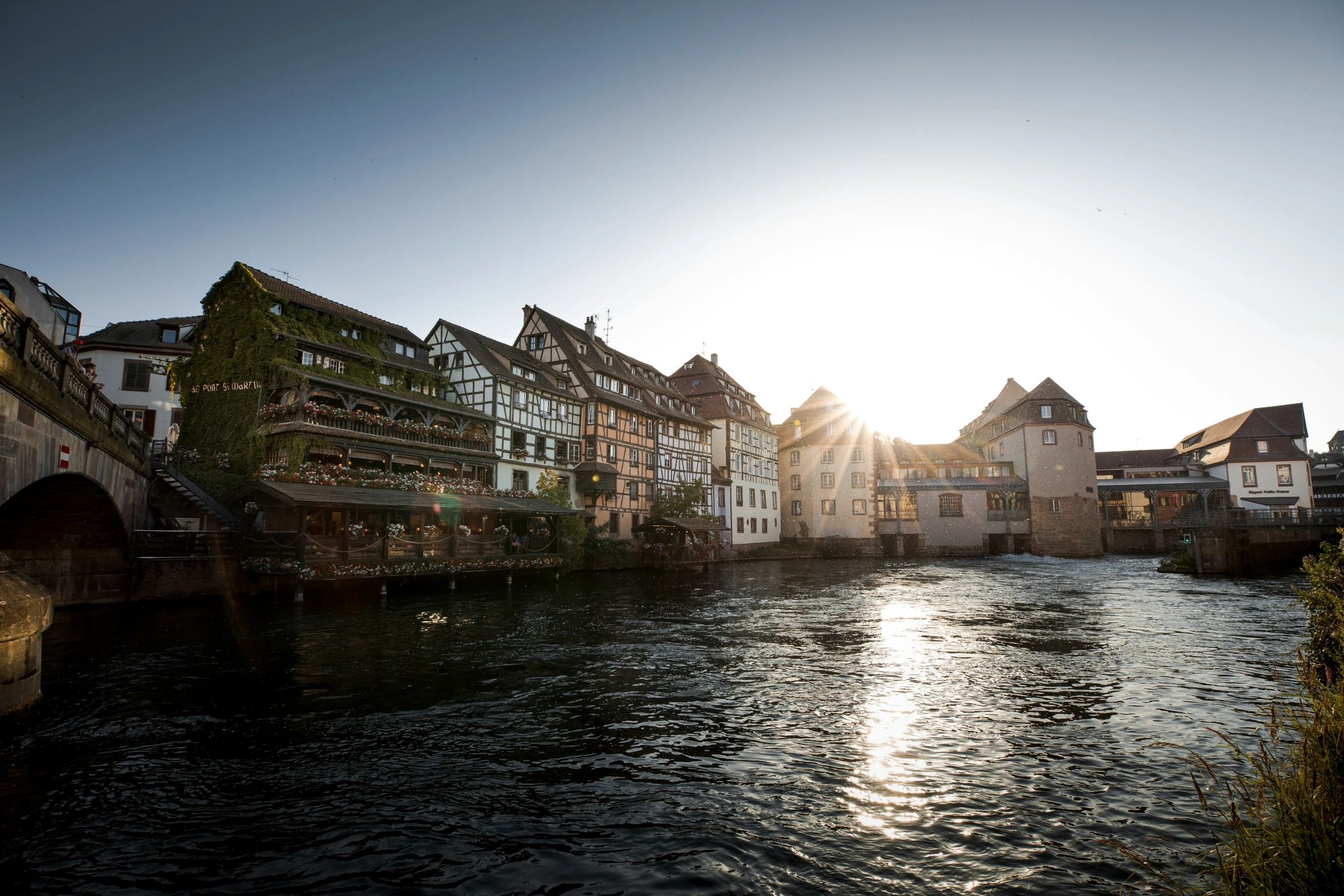 sun is shining in the middle of an old city