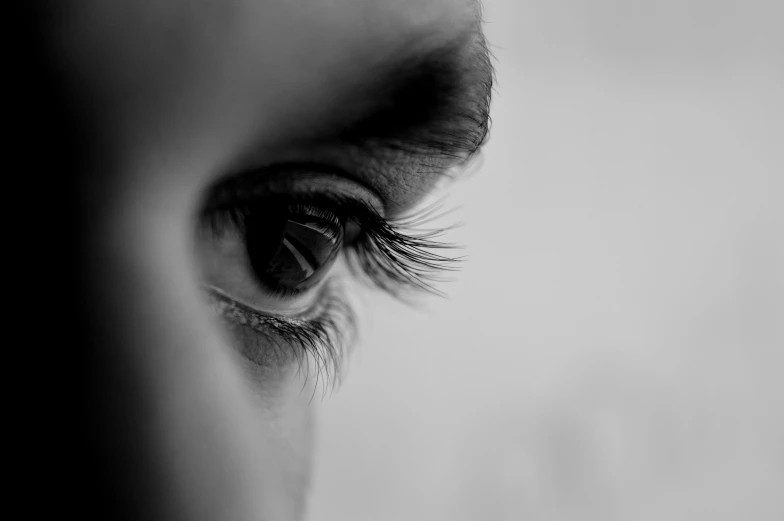 the eye of a person is shown as they stand in front of them