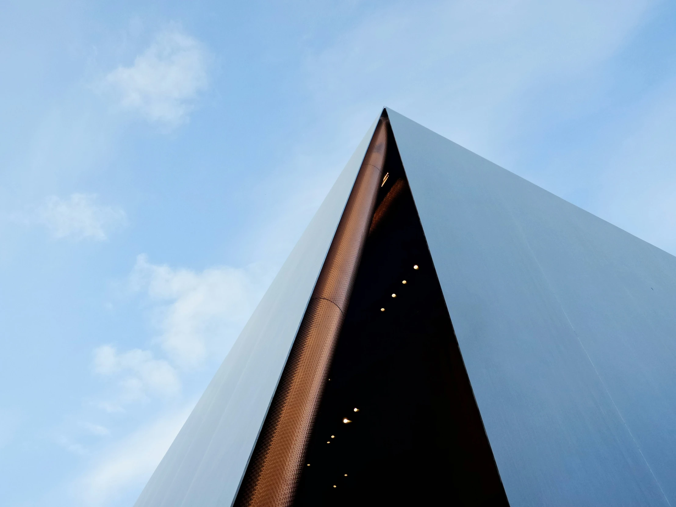 the triangular structure is standing in front of a blue sky