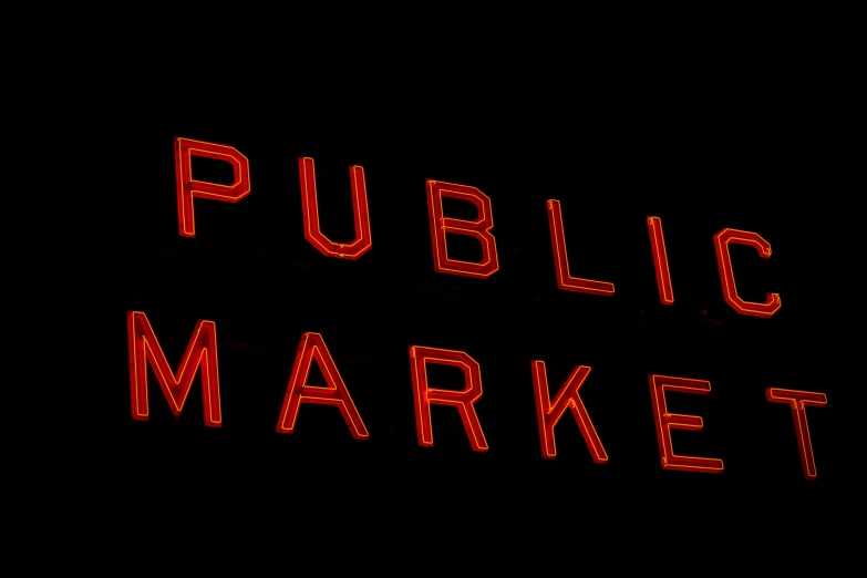 there is a red neon sign that says public market