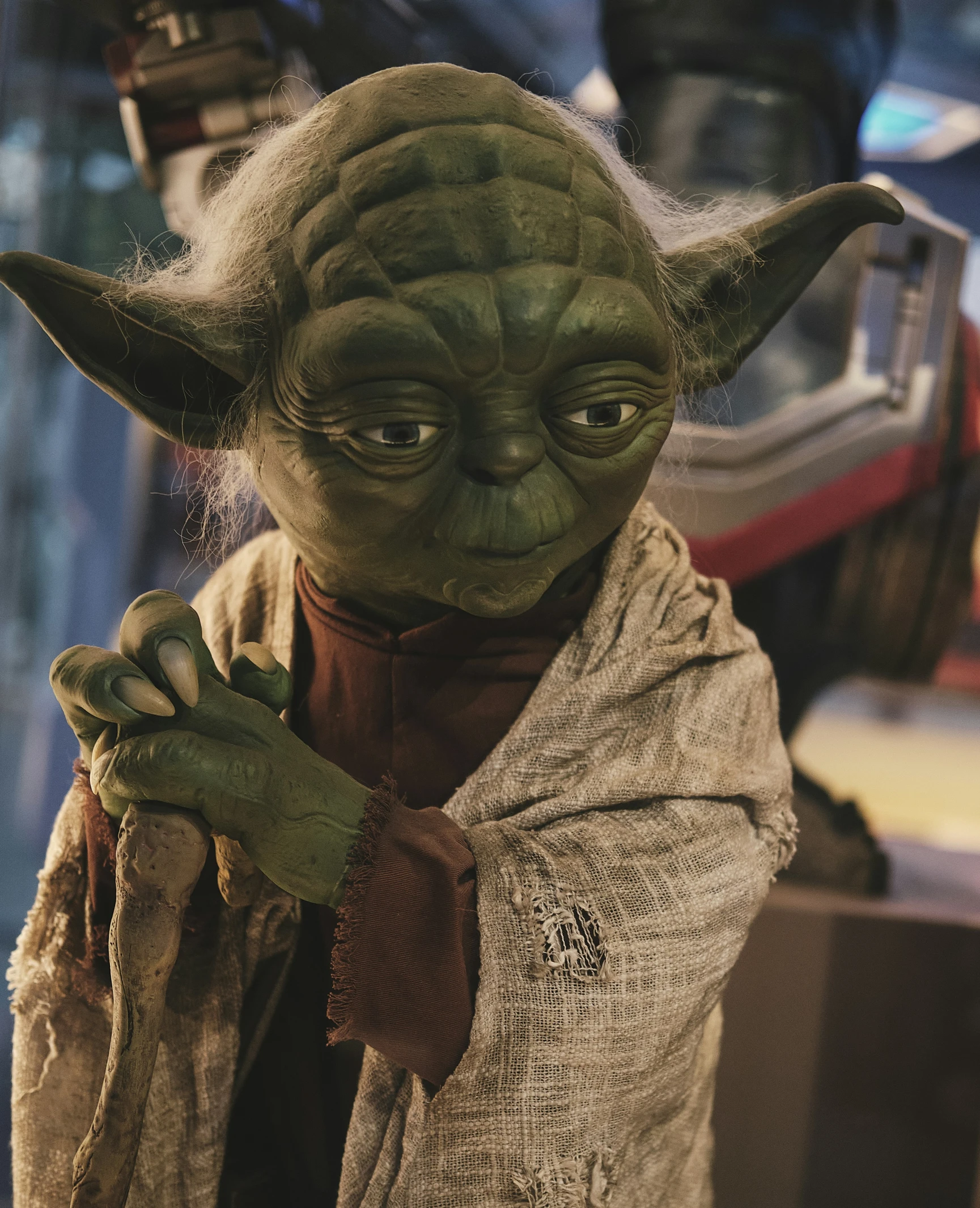 a yoda character holding soing with his hand