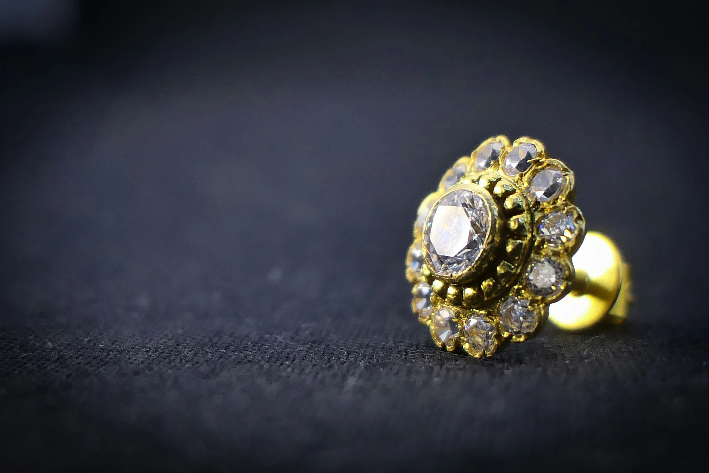 an upclose image of a yellow ring with several white stones