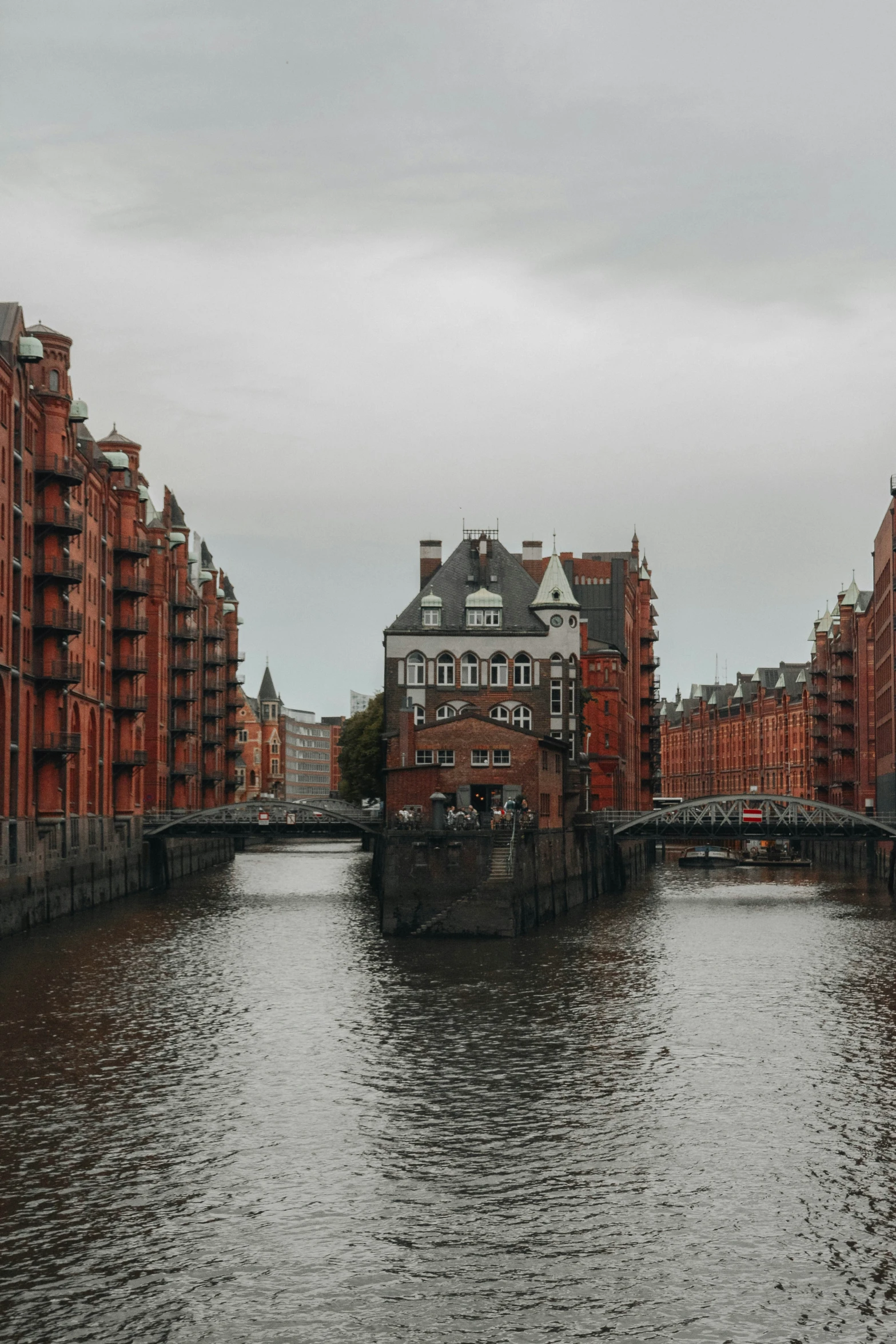 city buildings on both sides of a river with a bridge in the center