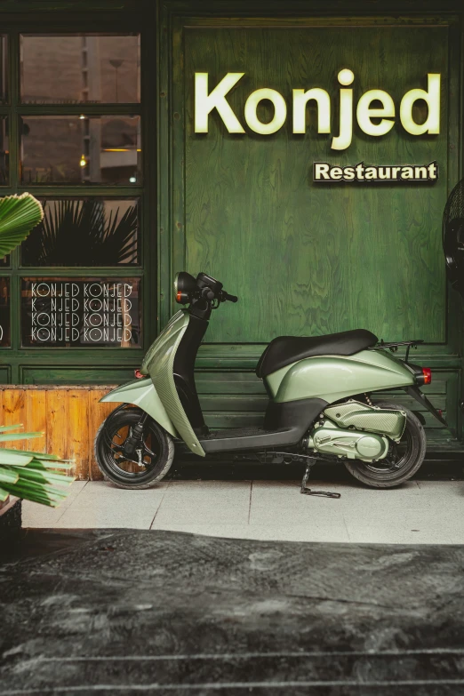 a scooter parked outside of a restaurant near a sign