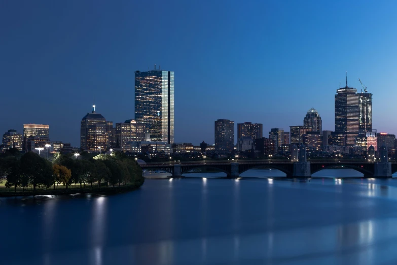 a city skyline across the river at night