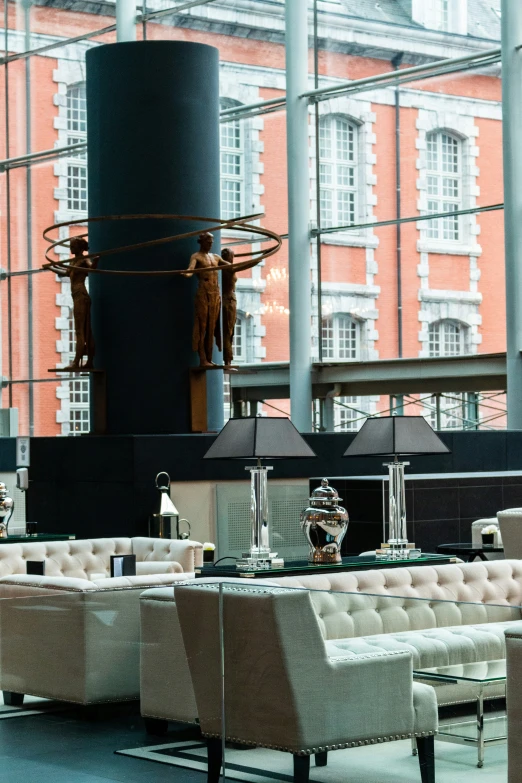 an empty lobby with lots of furniture and large windows