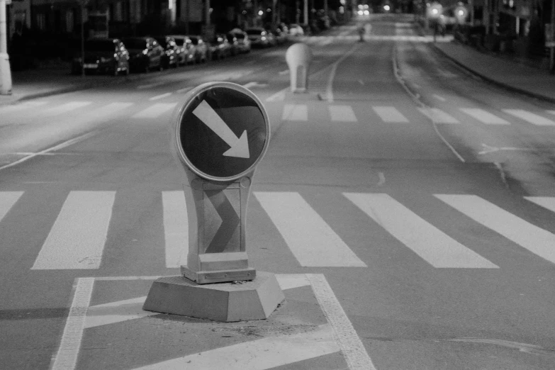 an empty street with a cross walk sign on it