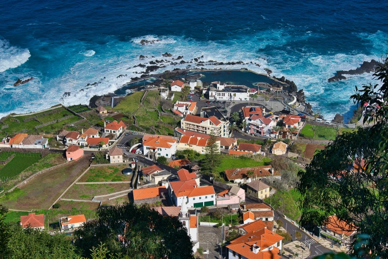 an aerial view of a town on the coast of the ocean