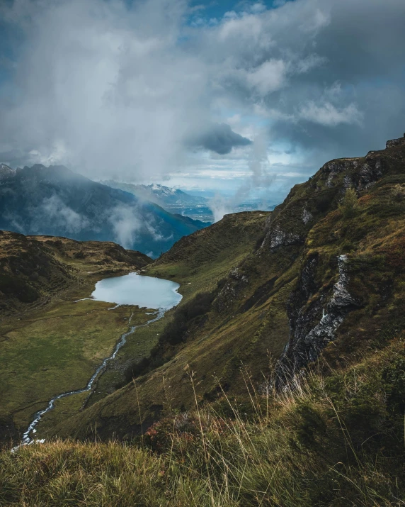 the water sits in between the mountains and on a cloudy day