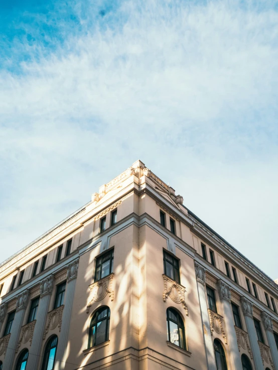 a large white building sitting under a bright blue sky