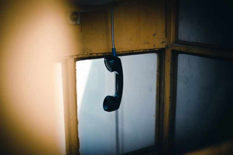 an old phone hanging on a wall in a room
