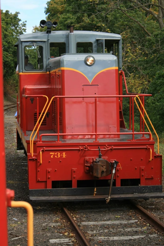 a train sitting on a track, with trees in the background