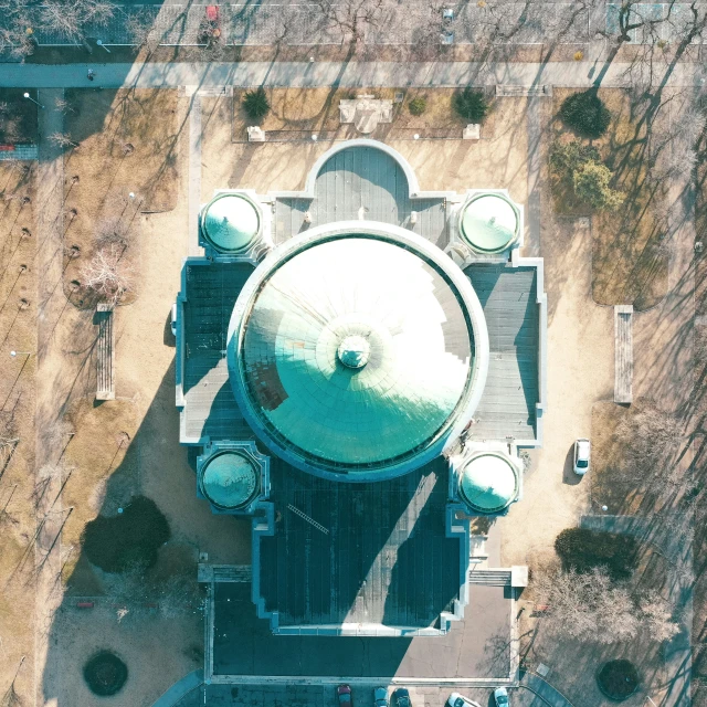 aerial view of giant clock tower with tree in the background