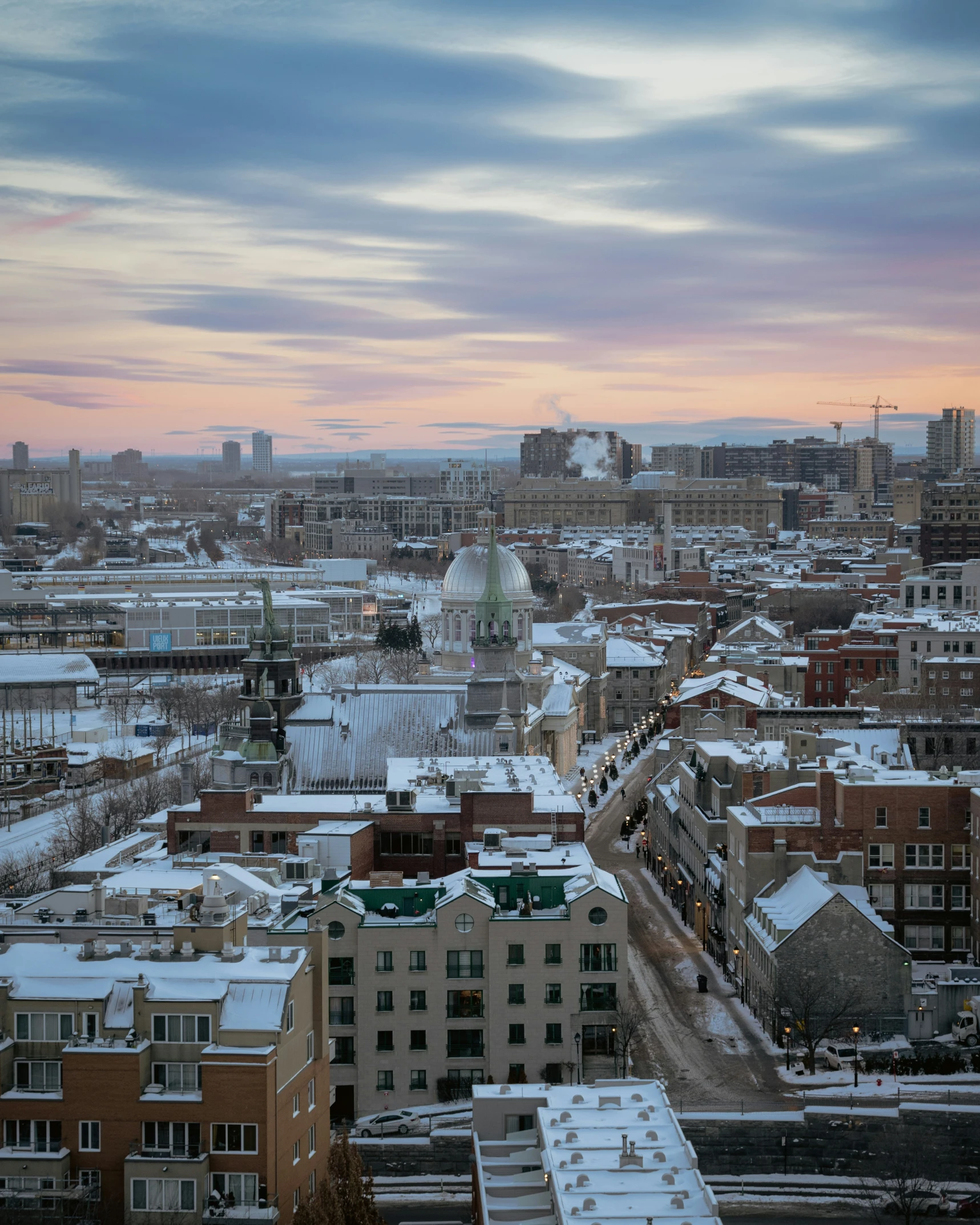 the city is all covered in snow at sunset