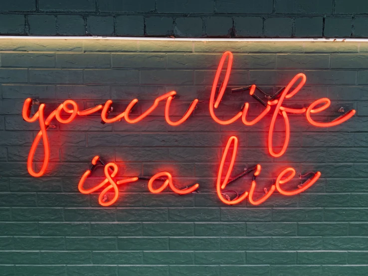 a neon sign that says you're life sale