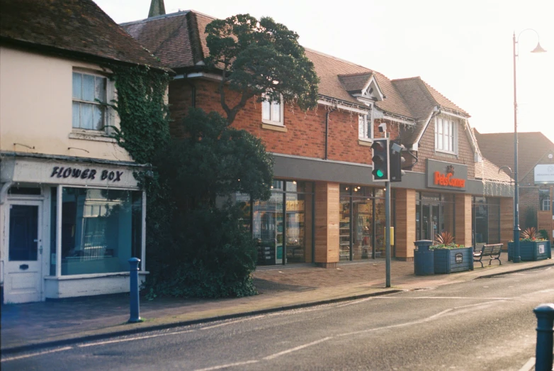 an empty street is lined with shops and small buildings