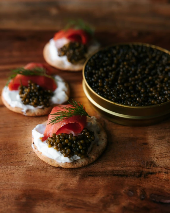 three small ers filled with various toppings on top of a wooden table