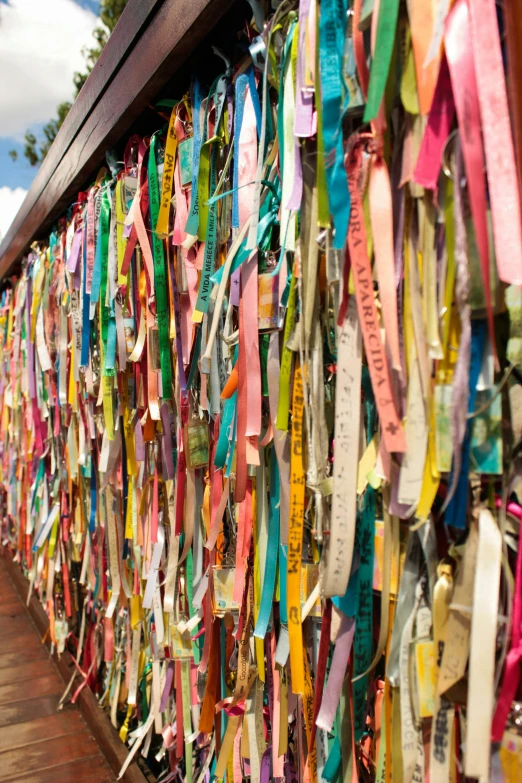 many ribbons on display along a wall in an alley