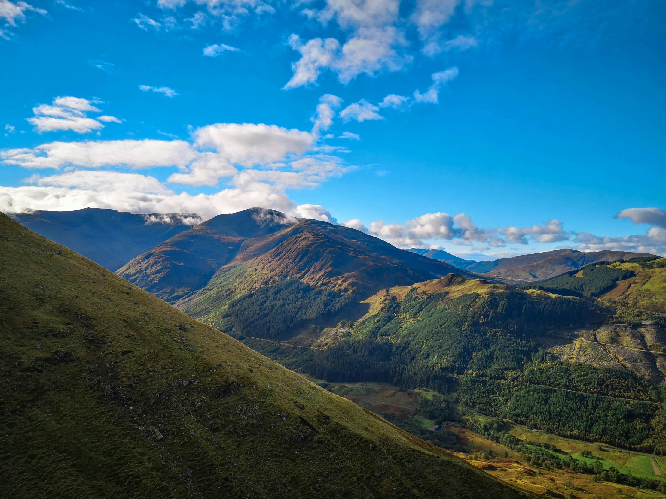 some mountains and a blue sky with clouds