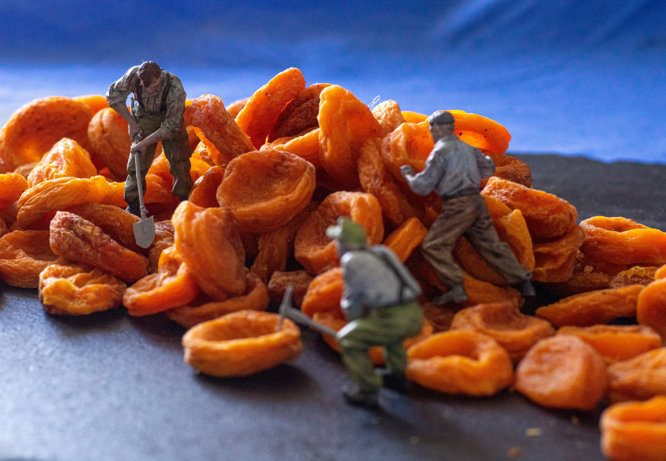 a pile of orange rings with toy soldiers standing near them