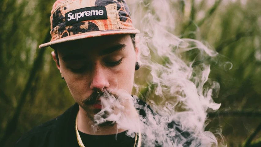 young man with smoke coming out from his mouth