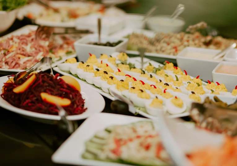 different types of food is on plates lined up