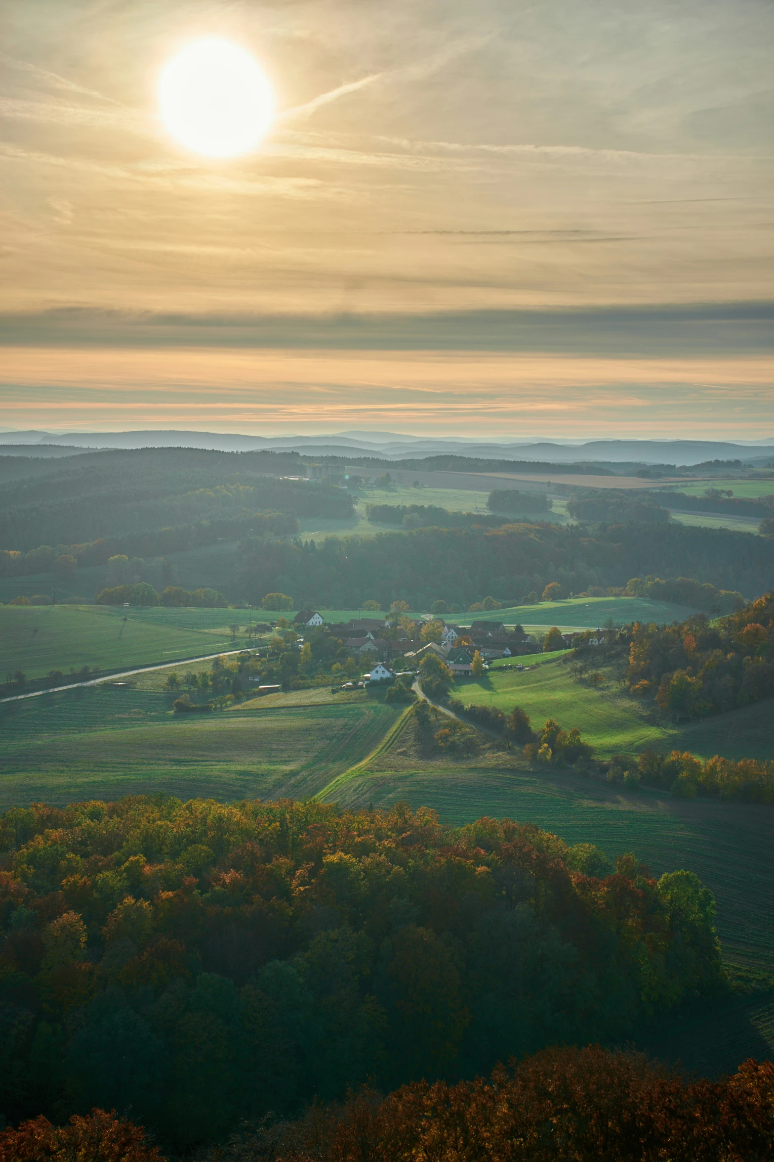 an overview of lush green countryside and sun