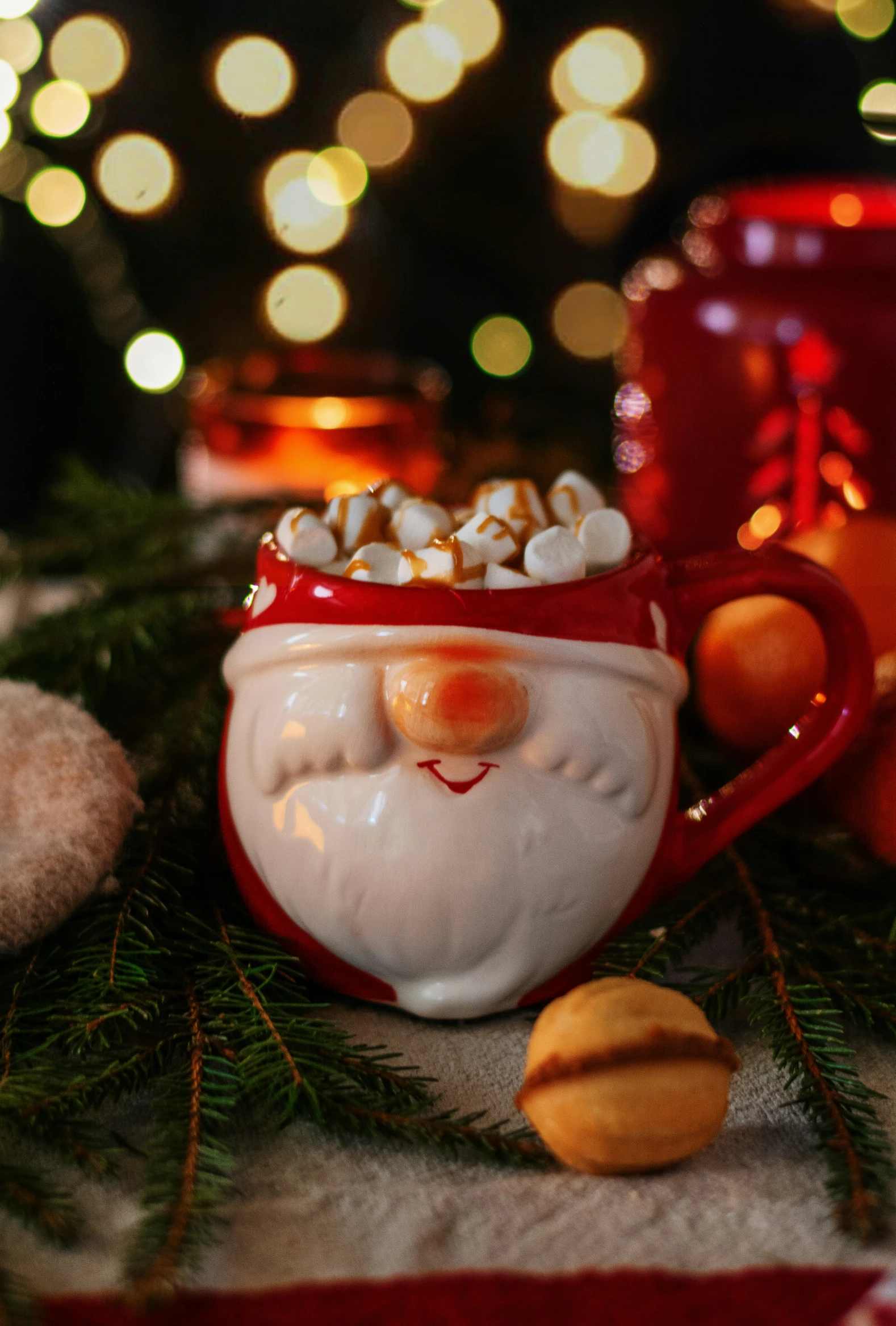 a cup is decorated with candies and an ornament