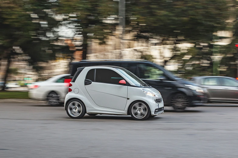 smart car going fast on the road with another car