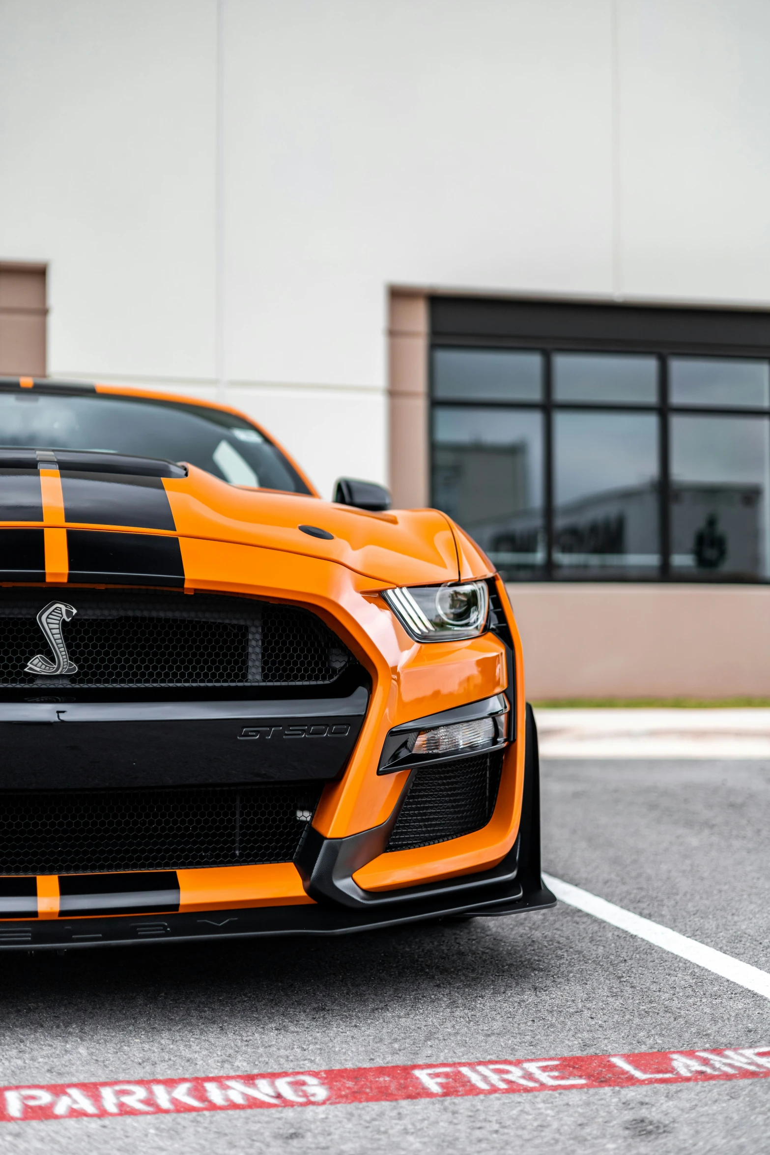 the orange and black car has striped stripes on it