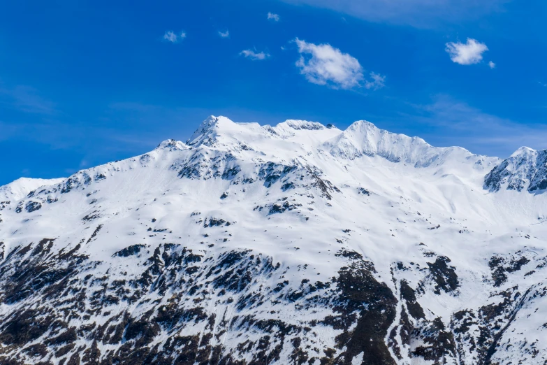 snow covered mountains on the top of a hill