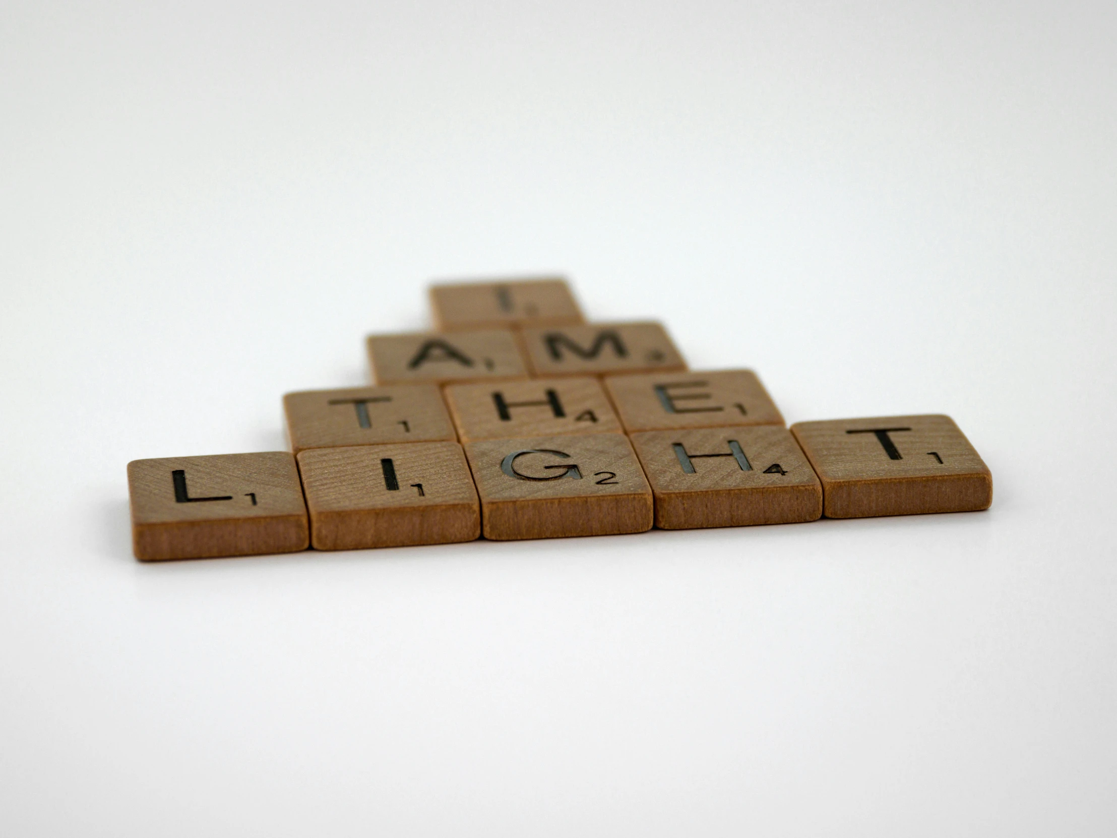 a scrabble type block that has words that read i am the light