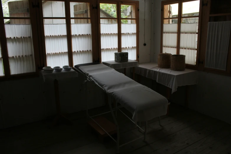 a room with some very big windows with small tables on the inside