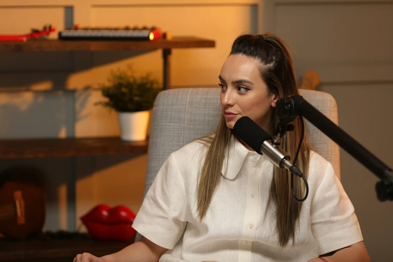 a woman sitting down and listening to someone on her phone