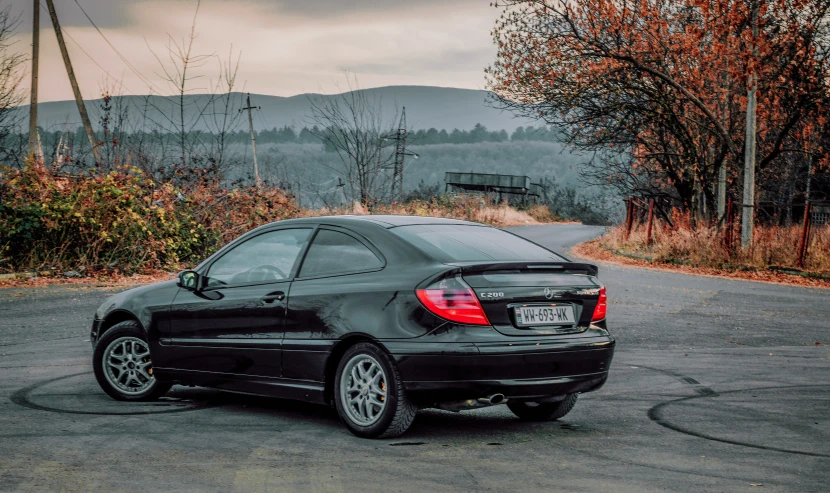 a black bmw is parked on the street