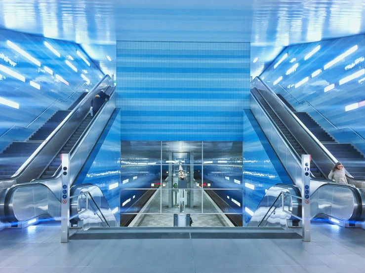 the escalator of a train station with people on their boards