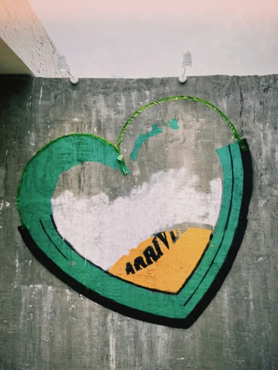 a wall with graffiti on it and a green heart