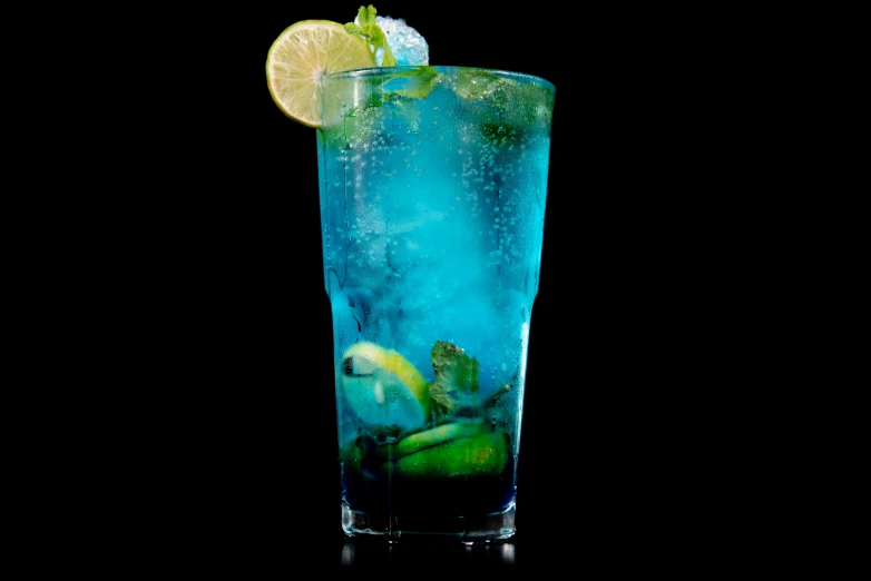 there is a blue drink with a lime and lime in it