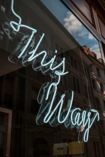 the shop's window displays this sign in neon lights